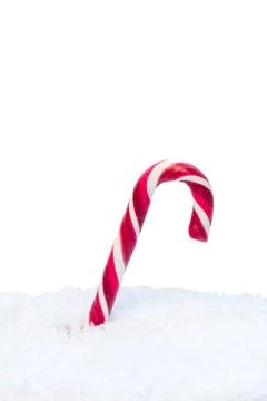 Candy cane in snow Stock Photos