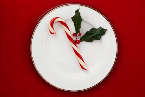 Candy cane on a white plate Stock Photos