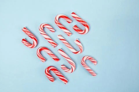 Candy canes on blue background - top view with copy space Stock Photos