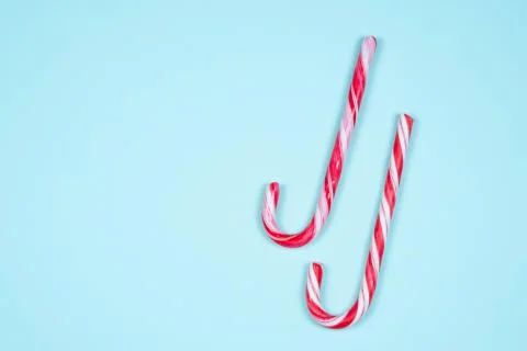 Candy canes on a light blue background Stock Photos