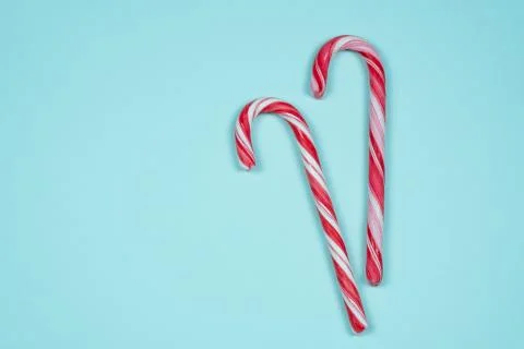 Candy canes on a light blue background Stock Photos