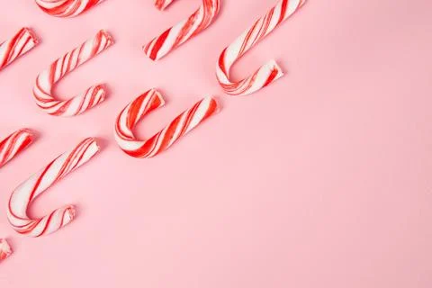 Candy canes pattern on pink background - top view with copy space Stock Photos