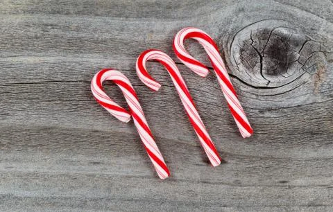 Candy canes on rustic wood Stock Photos