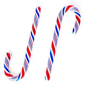 Candy canes on a white surface, top view, place for text Stock Photos