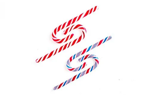 Candy canes on a white surface, top view, place for text 库存照片