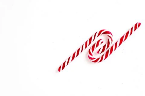 Candy canes on a white surface, top view, place for text 写真素材