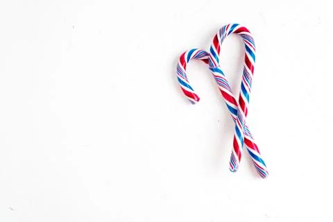 Candy canes on a white surface, top view, place for text Photos