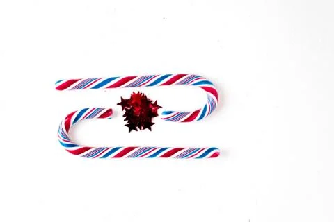Candy canes on a white surface, top view, place for text 库存照片
