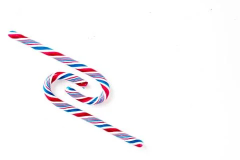 Candy canes on a white surface, top view, place for text Stock Photos