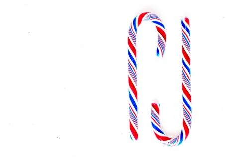 Candy canes on a white surface, top view, place for text Stock Photos