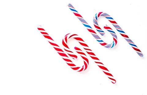 Candy canes on a white surface, top view, place for text Stock Photos