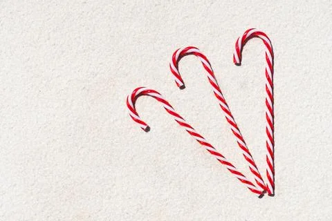 Candy canes on a white textured background. Copy space, top view. Merry Chris Stock Photos