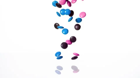 Candy chocolate falling against White Background, Slow Motion, 1000fps. Vibrant. Video stock 163721453