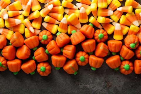 Candy corn and pumpkin Halloween background Stock Photos