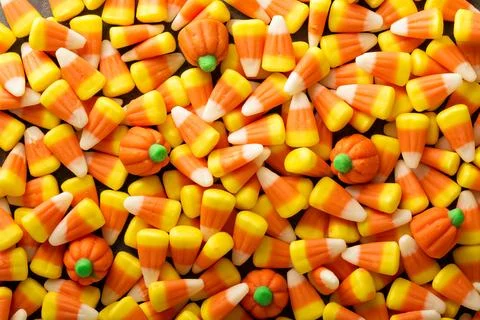 Candy corn and pumpkin Halloween background Stock Photos