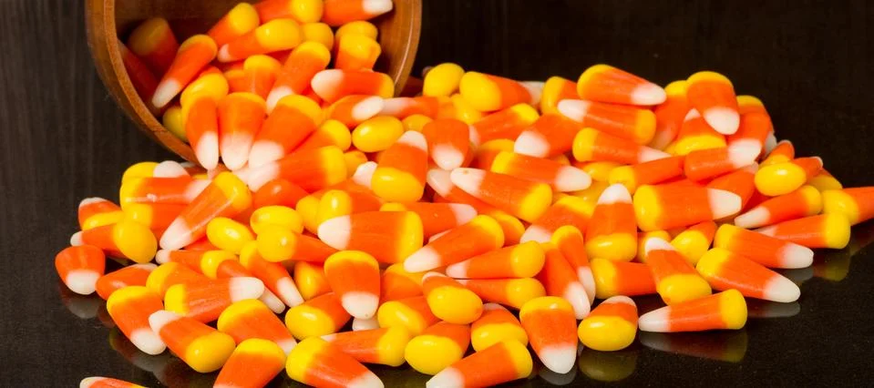 Candy corn spilling onto table Stock Photos