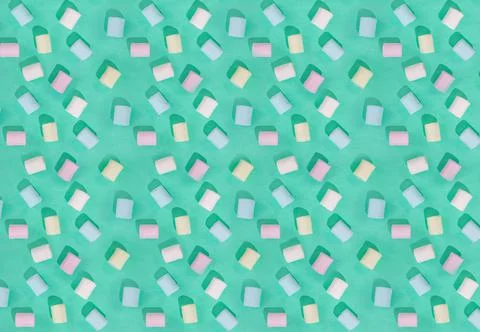 Candy of different colors on a turquoise background, texture Stock Photos