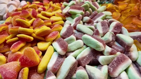 Candy display in store showcases various gummy treats Stock Footage 327885943