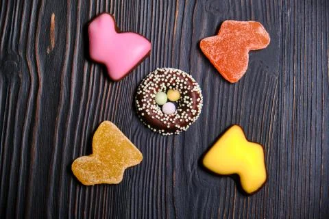 Candy for Easter in the form of a rabbit made of marmalade and chocolate eggs Stock Photos