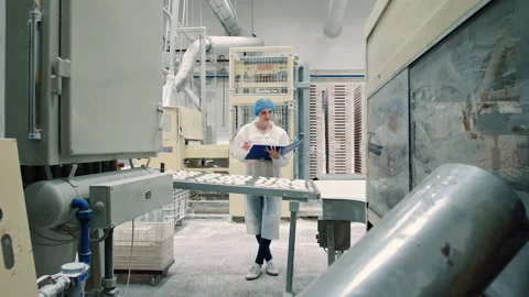 Candy factory. Controller checking conveyor with candies. Stock Footage 130231368