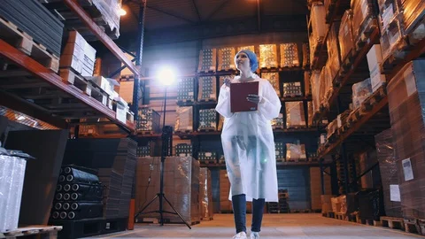 Candy factory. Controller checking factory storage room. Video stock 98030732