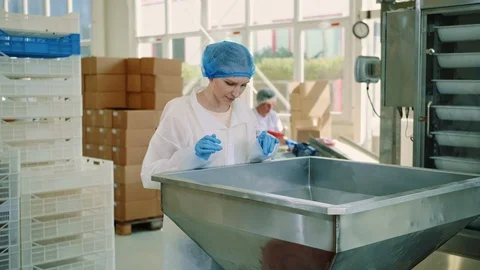 Candy factory. Factory worker checking packing machine. Stock Footage 98087792