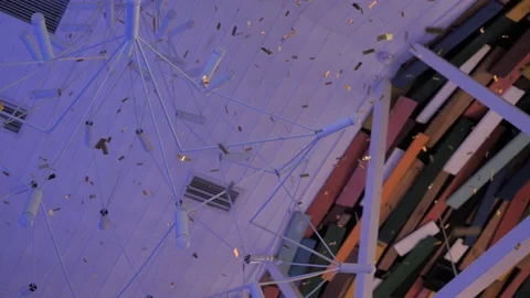 Candy flying from top to bottom against the ceiling of colored boards next. Video stock 106191210