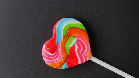 Candy heart rotation close up black background Stock Footage 212920928