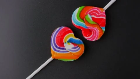 Candy heart rotation close up black background3 Video stock 212921130