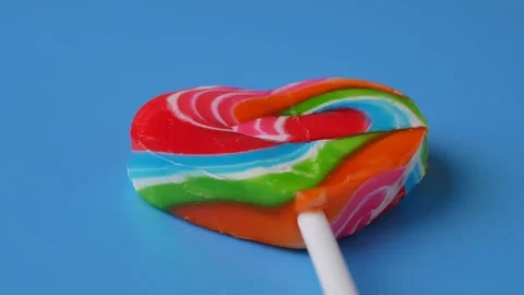 Candy heart rotation close up blue background Video stock 212920242