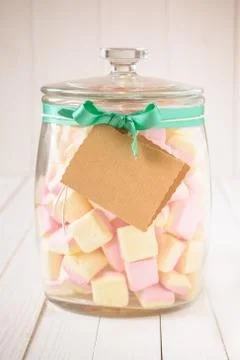 Candy jar filled with marshmallows and a blank tag Stock Photos