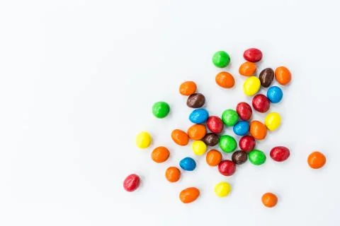 Candy lying on white background. Bright and Colorful sweets top view. Flat la Stock Photos