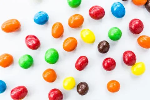 Candy lying on white background. Bright and Colorful sweets top view. Flat la Stock Photos