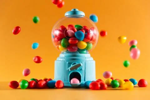 Candy machine with jelly beans, multicoloured jelly beans, orange background Stock Photos