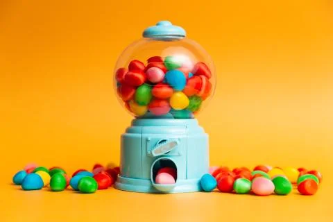 Candy machine with jelly beans, multicoloured jelly beans, orange background Stock Photos