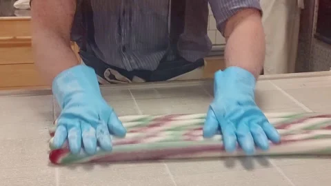 Candy Maker Rolling Fresh Candy Dough by Hand Stock Footage 312401202