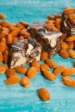 Candy paste and almonds on blue wooden background Stock Photos
