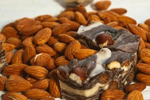 Candy paste and almonds on white wooden background Stock Photos