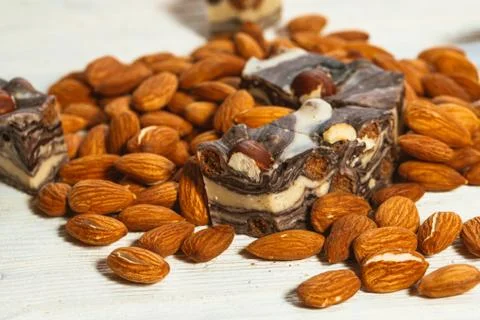 Candy paste and almonds on white wooden background Stock Photos