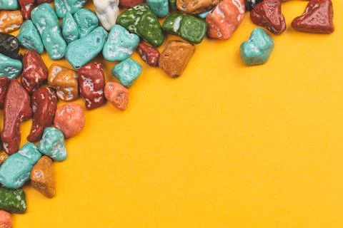 Candy pebbles on a yellow background. sweets in the form of colored stones. f Stock Photos