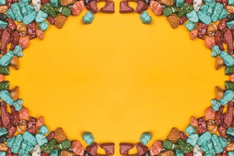 Candy pebbles on a yellow background. sweets in the form of colored stones. s Stock Photos