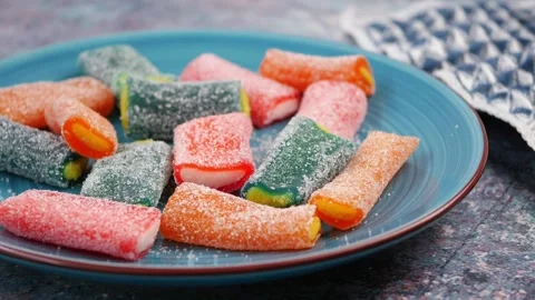 Candy placed on a blue plate with a napkin nearby Stock Footage 340862936