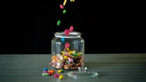 Candy Pouring into a Jar in Slow Motion Stock Footage 114972023