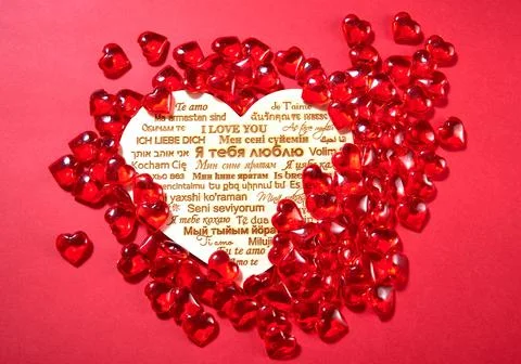 Candy in the shape of hearts on a red background. the inscription "I love you Stock Photos