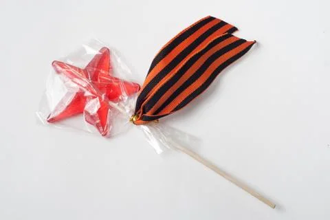 Candy in the shape of a star, a red candy on a stick in a bag, Stock Photos
