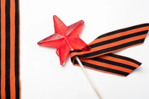 Candy in the shape of a star, a red candy on a stick, Stock-Fotos