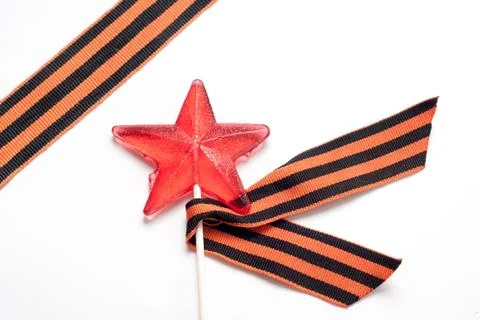 Candy in the shape of a star, a red candy on a stick, Foto stock