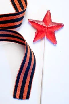 Candy in the shape of a star, a red candy on a stick, Stock-Fotos