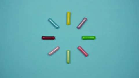 Candy sticks move in a circle as a symbol of waiting. Stop motion Stock-Footage 169007659