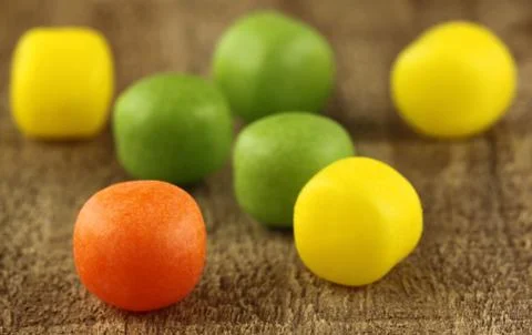 Candy on wooden surface Stock Photos
